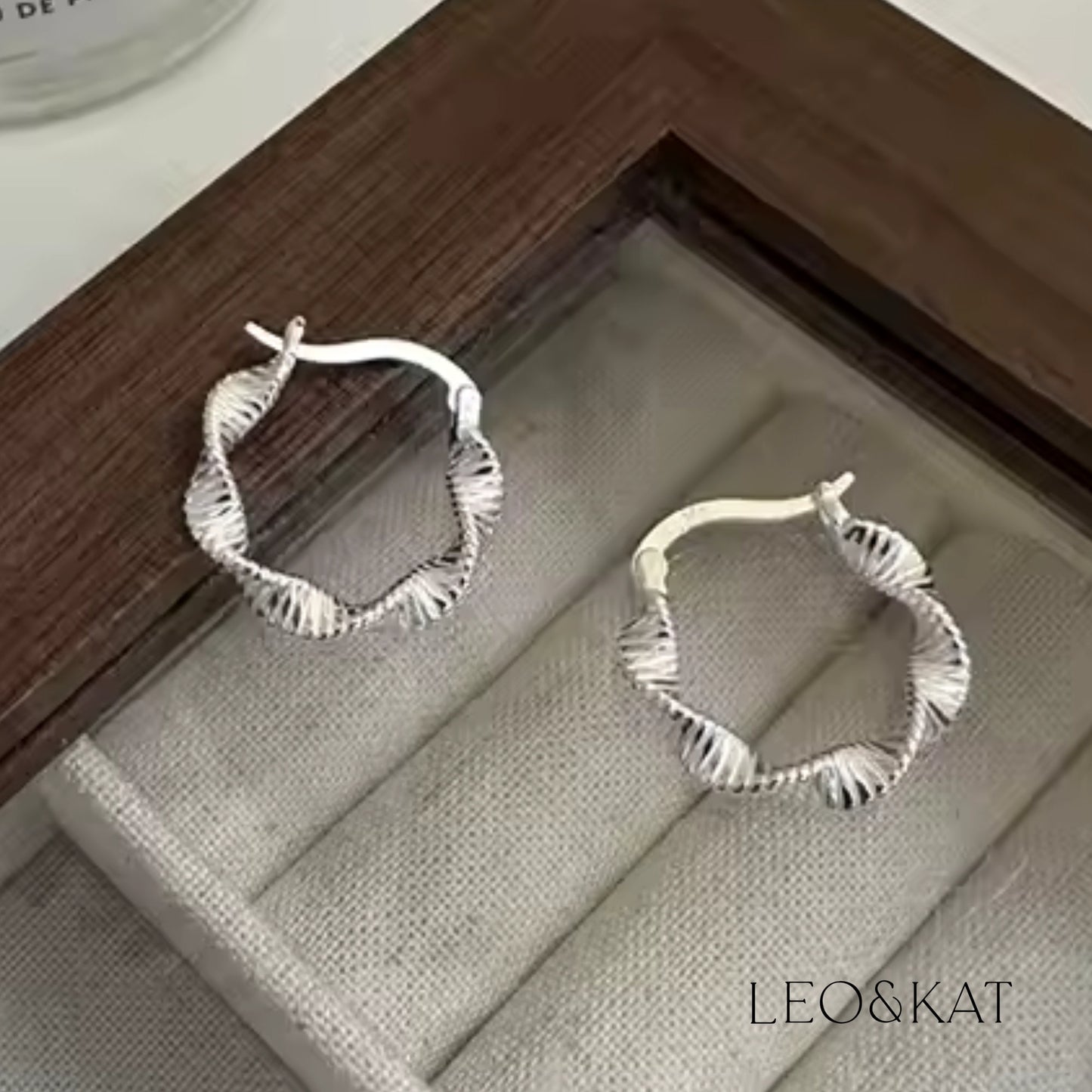 Modern Twisted Silver Hoop Earrings