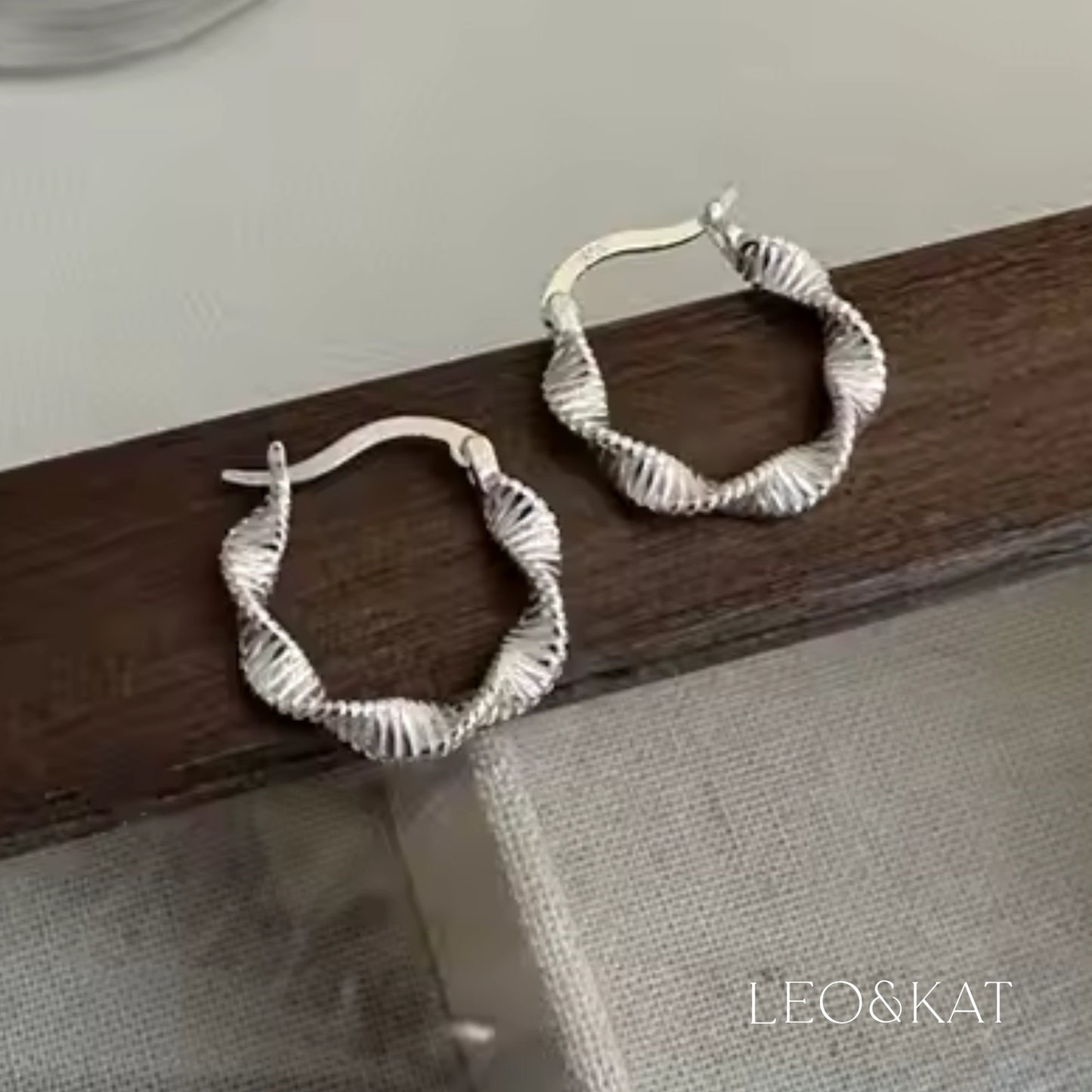 Modern Twisted Silver Hoop Earrings